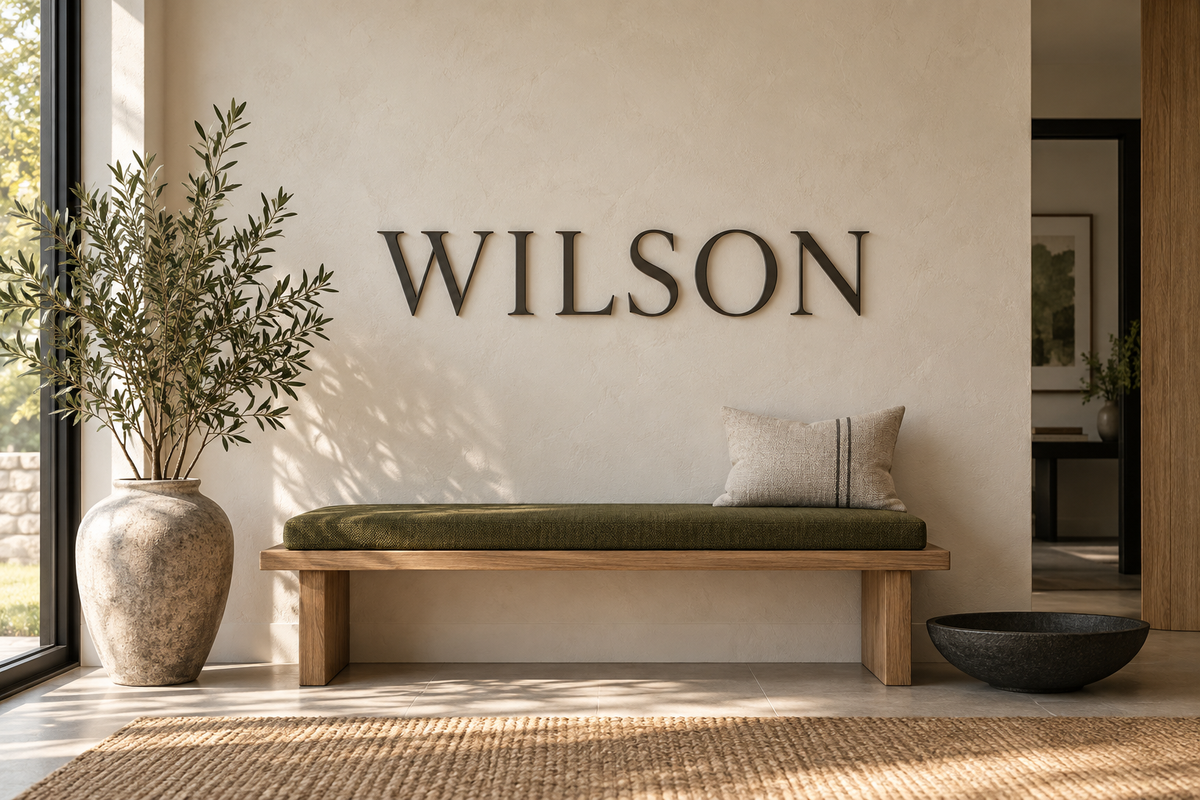 Wilson name wall lettering over an oak bench with an olive cushion; AI-generated concept.