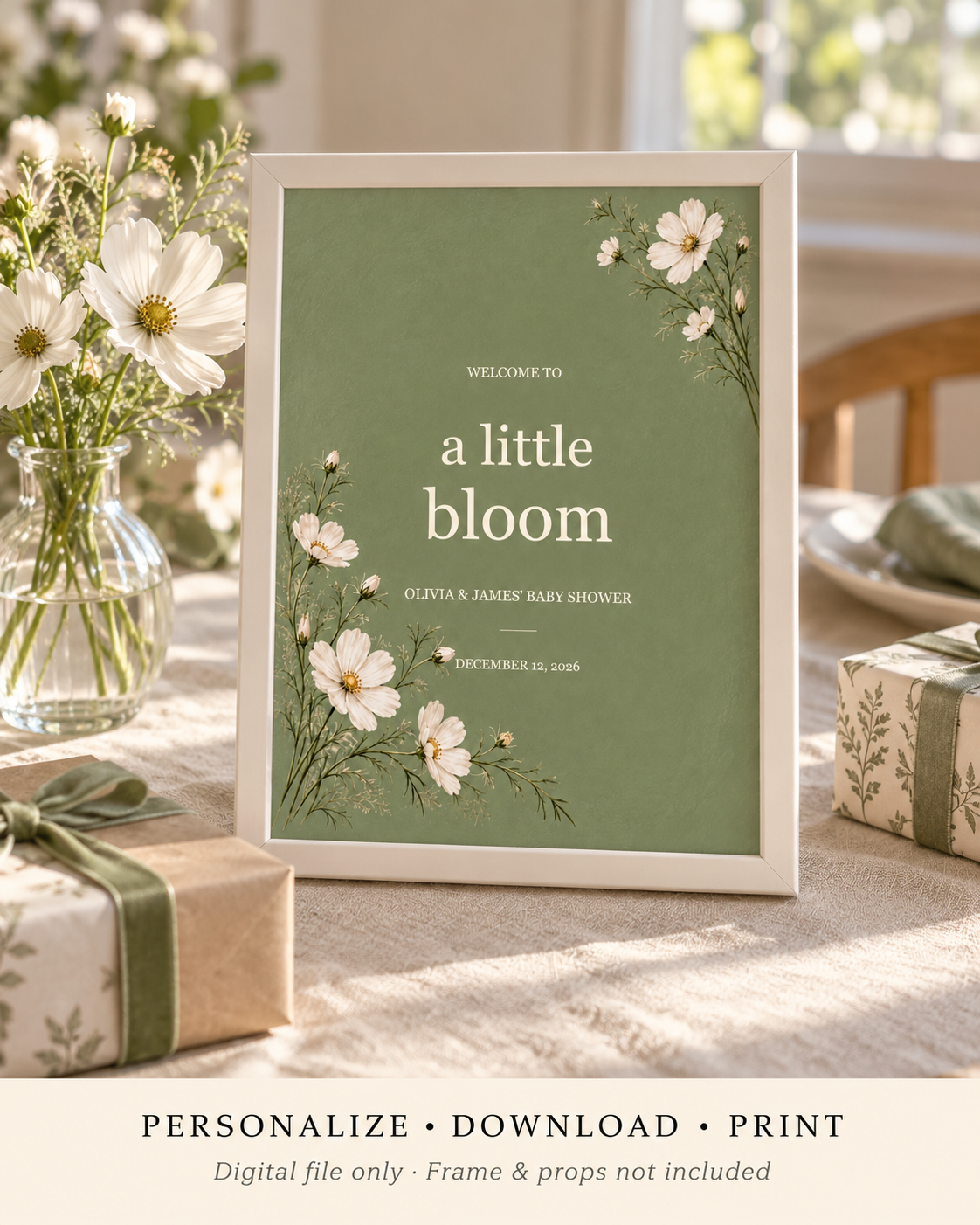 Little Bloom sage floral baby shower sign in an ivory frame on a home gift table. Digital template mockup; frame and props not included.